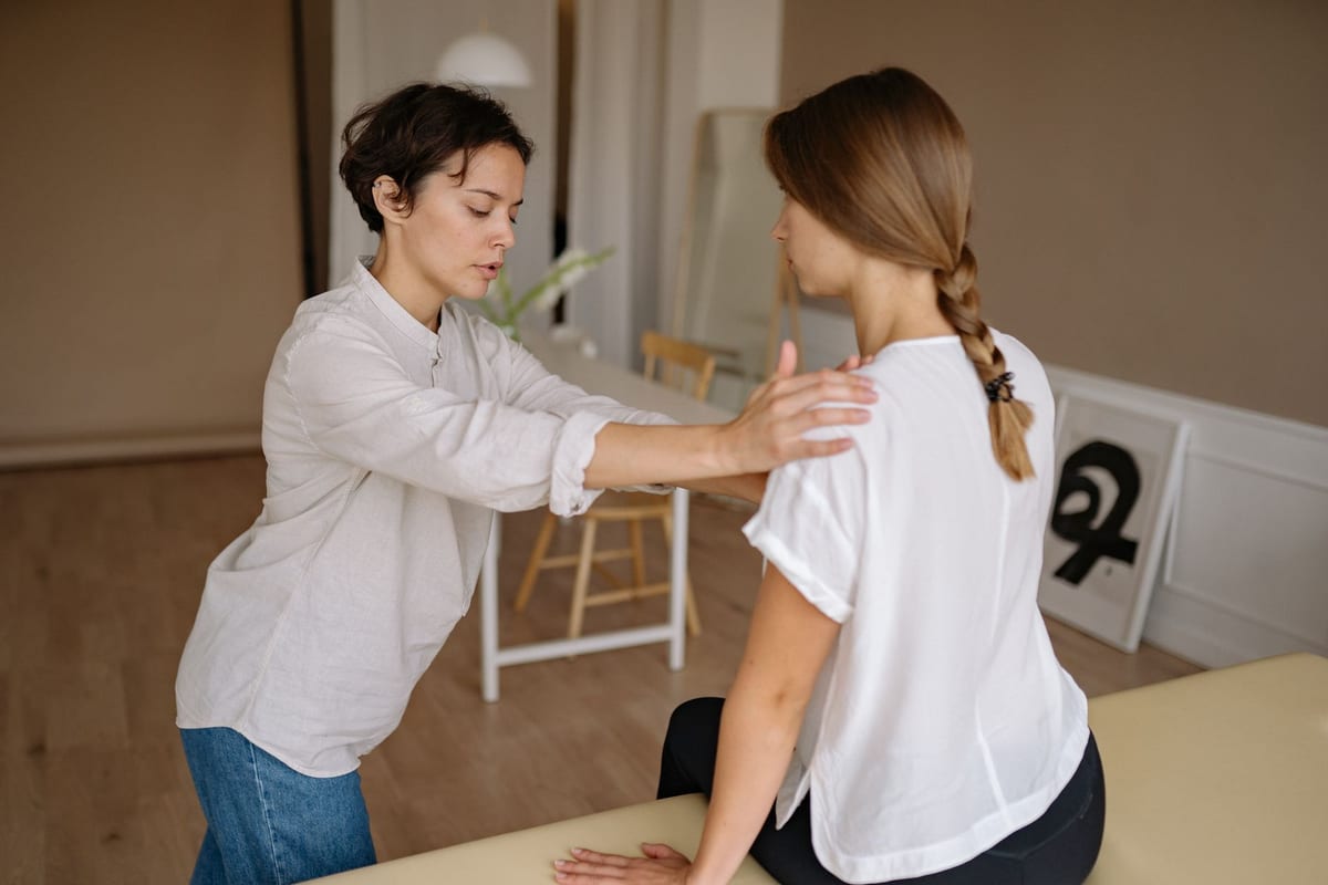 A seated shoulder assessment during an appointment
